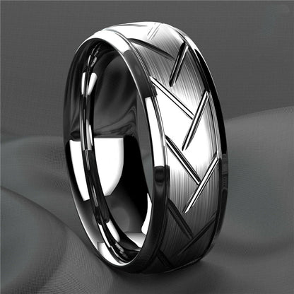 Silver ring with geometric design on a gray background