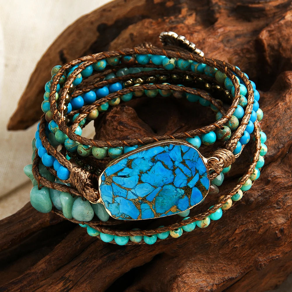 Turquoise beaded bracelet with a large blue stone on a wooden surface