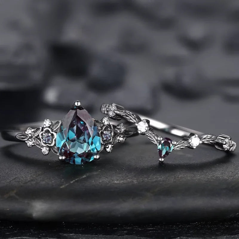 Silver ring with a large blue gemstone on a dark textured background