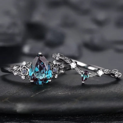 Silver ring with a large blue gemstone on a dark textured background