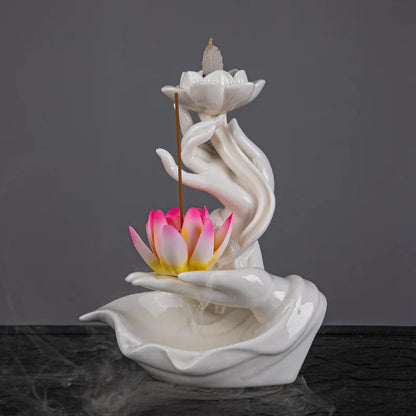 Ceramic incense burner with lotus design on a dark background