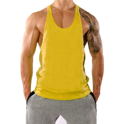 Person wearing a yellow tank top and gray pants on a white background