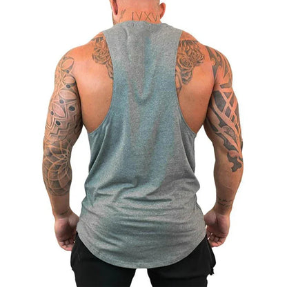 Person wearing a gray tank top with visible tattoos on arms and back