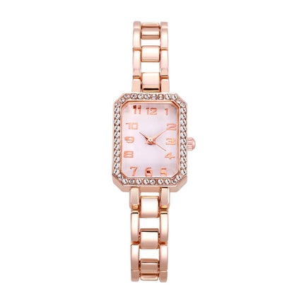 Rose gold watch with a white face on a white background