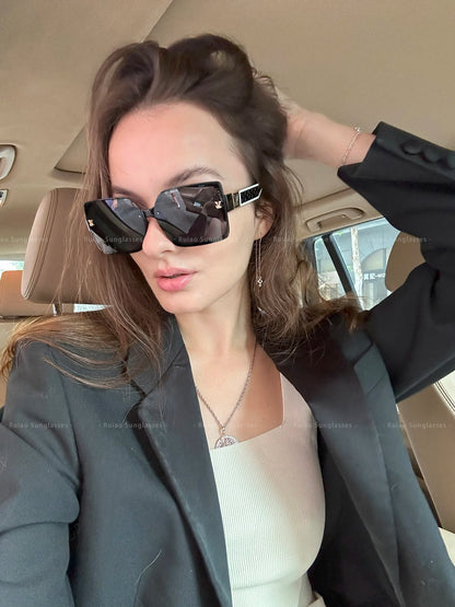 Woman wearing sunglasses inside a car