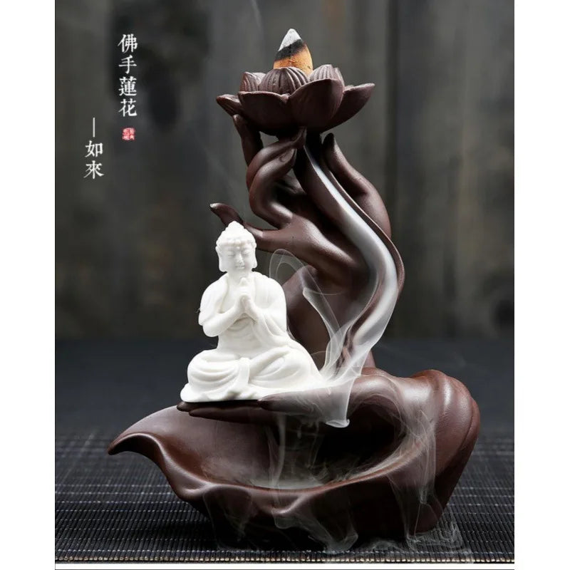 Decorative incense burner with a Buddha statue and lotus design on a dark background
