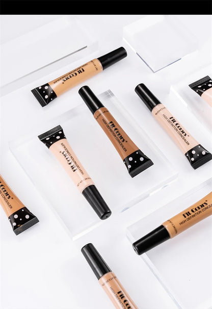 Set of Concealer tubes with black caps on a white background