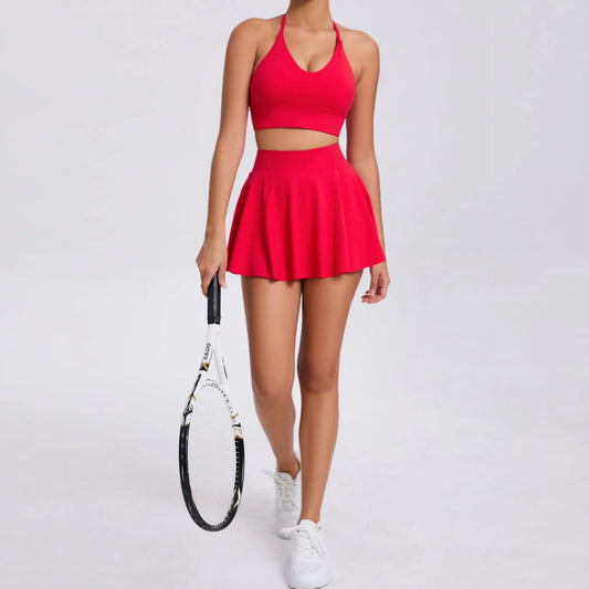 Person wearing a red tennis outfit holding a racket on a white background