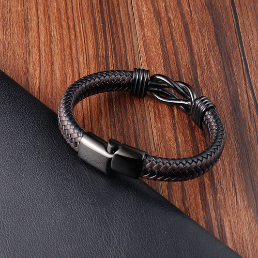 Black braided leather bracelet on a wooden surface