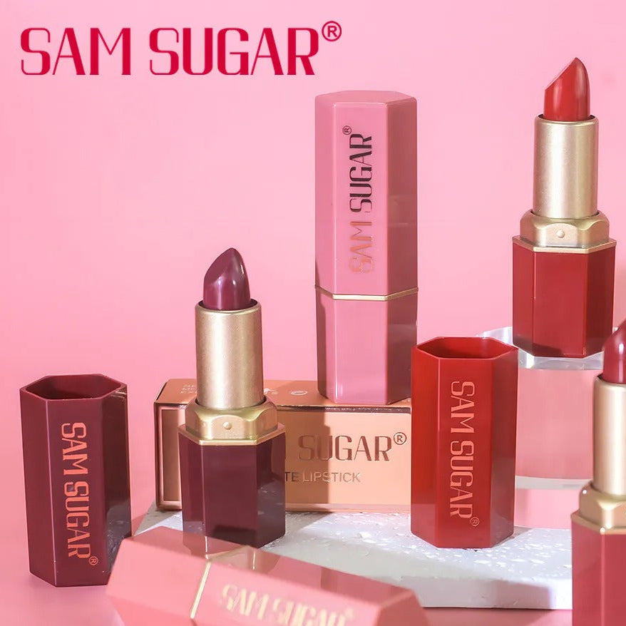 SAM SUGAR lipsticks and lip balm on a pink background