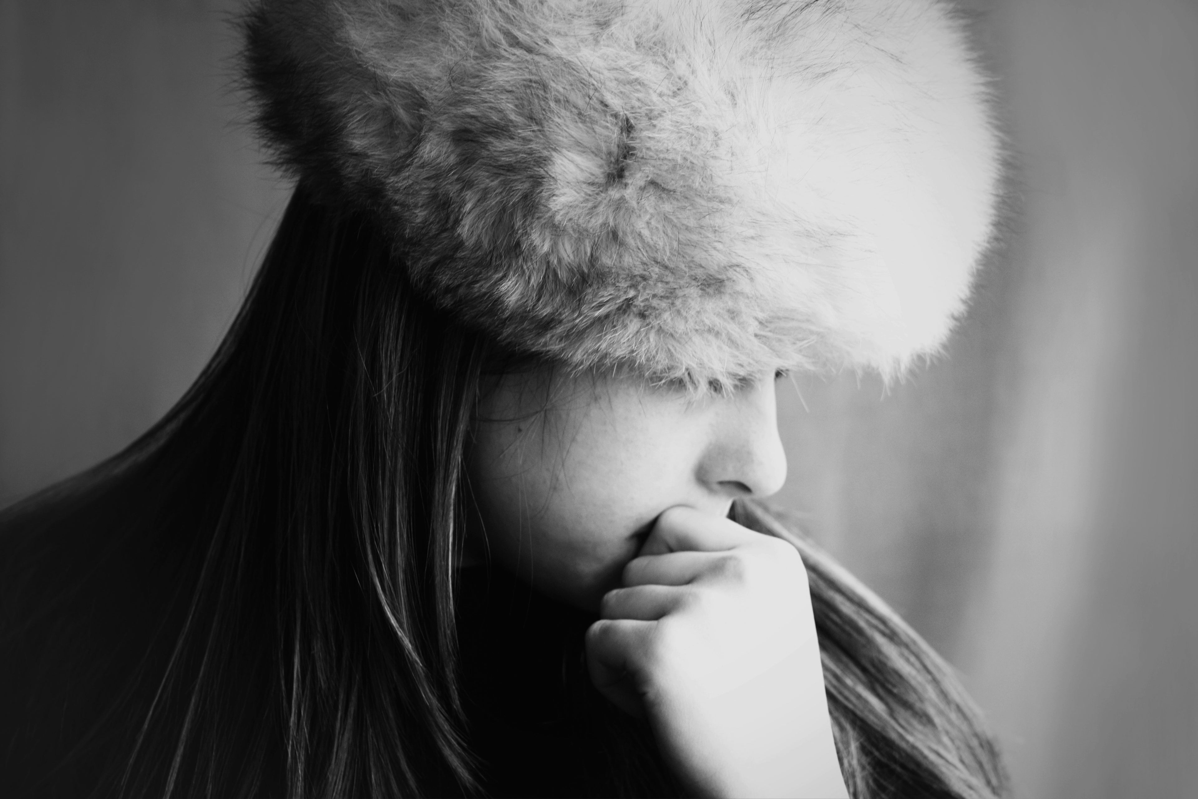 Person wearing a fur hat with a blurred background
